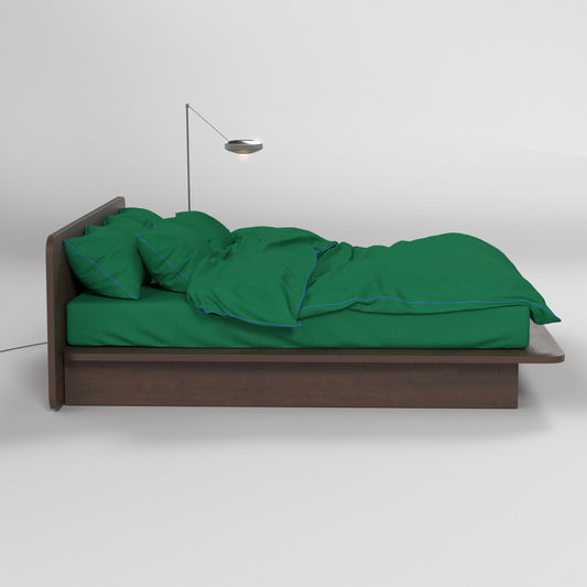 Aesthetic green bedding by BUTTIA with dark blue piping accents on natural cotton fabric.