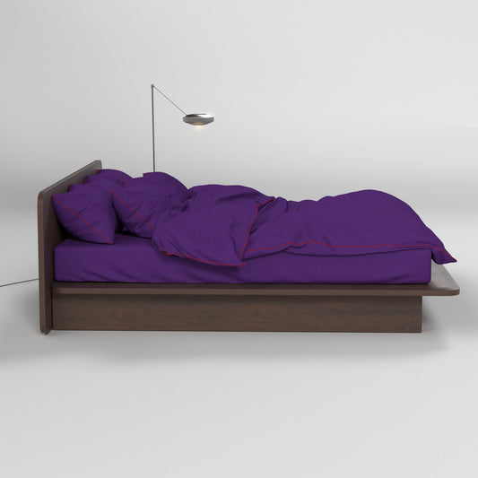 Deep purple cotton bedsheets from BUTTIA with stylish red piping for a modern bedroom interior.