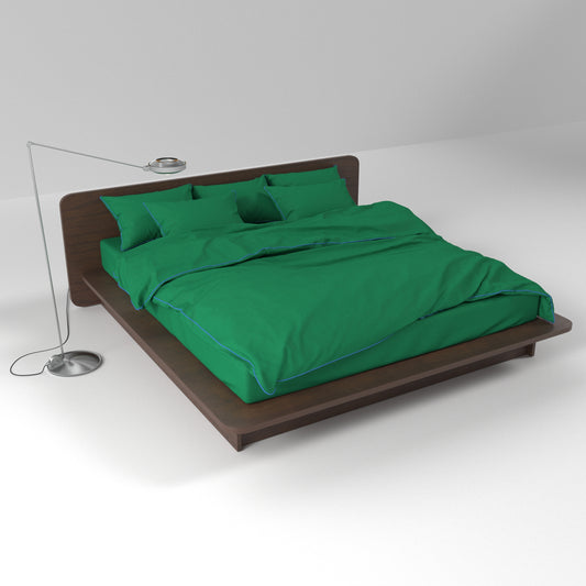 Green cotton bedding set by BUTTIA with stylish blue piping, including a duvet cover, bed sheet and matching pillowcases.