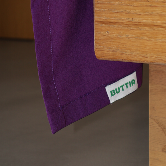 Classic flat bed sheet by BUTTIA made of high quality purple cotton with brand logo.