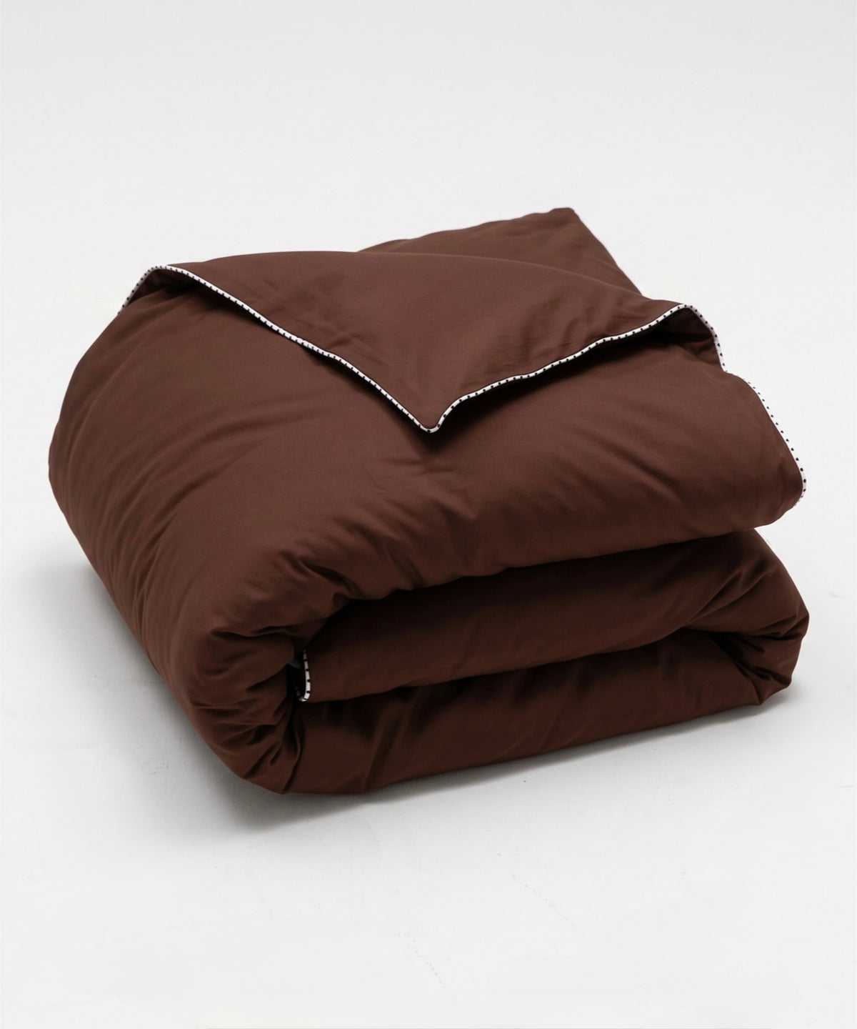 A folded brown quilted comforter with white contrast stitching along the edge, displayed on a clean white background.