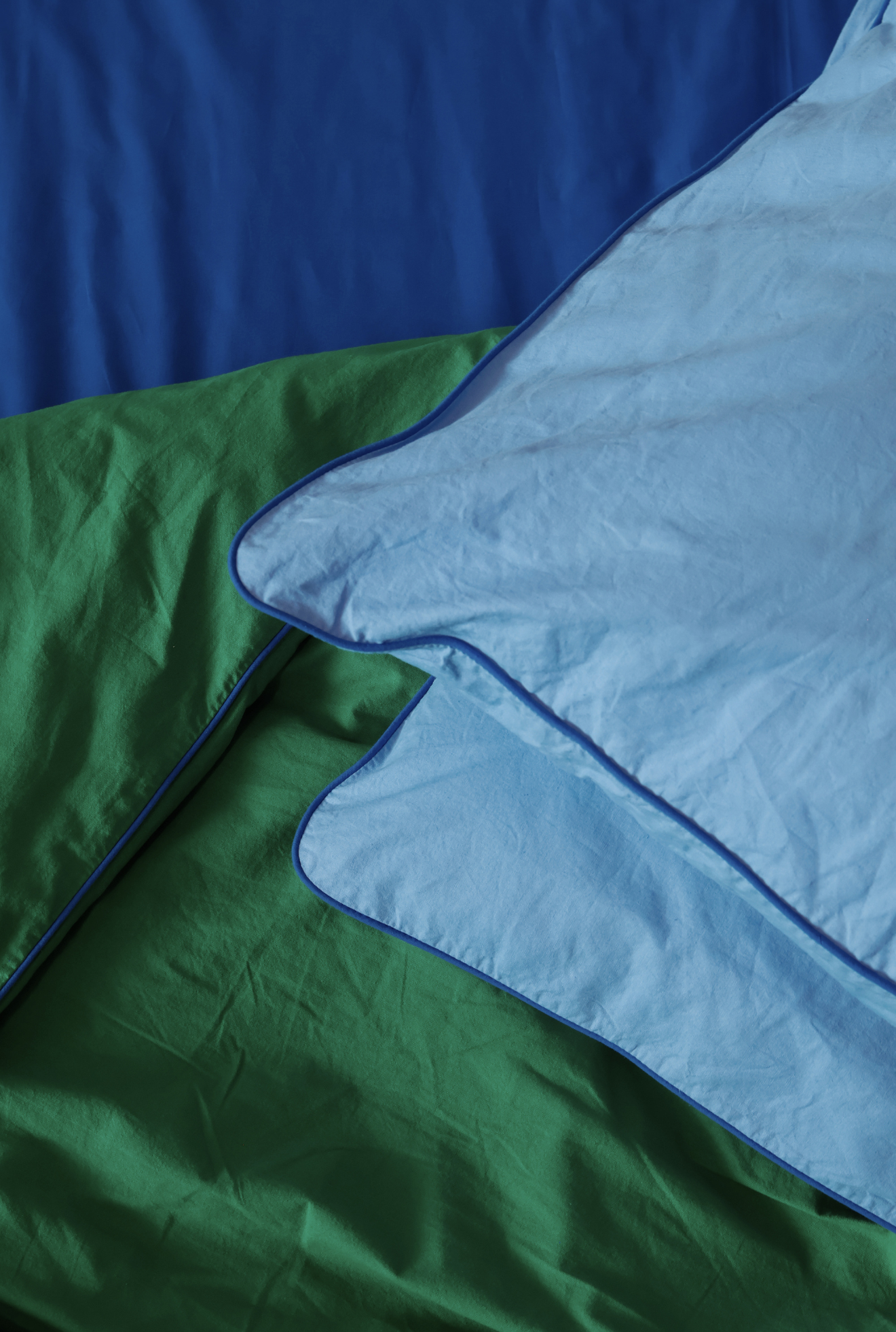 Close-up of green, blue, and gray fabric with a textured surface.