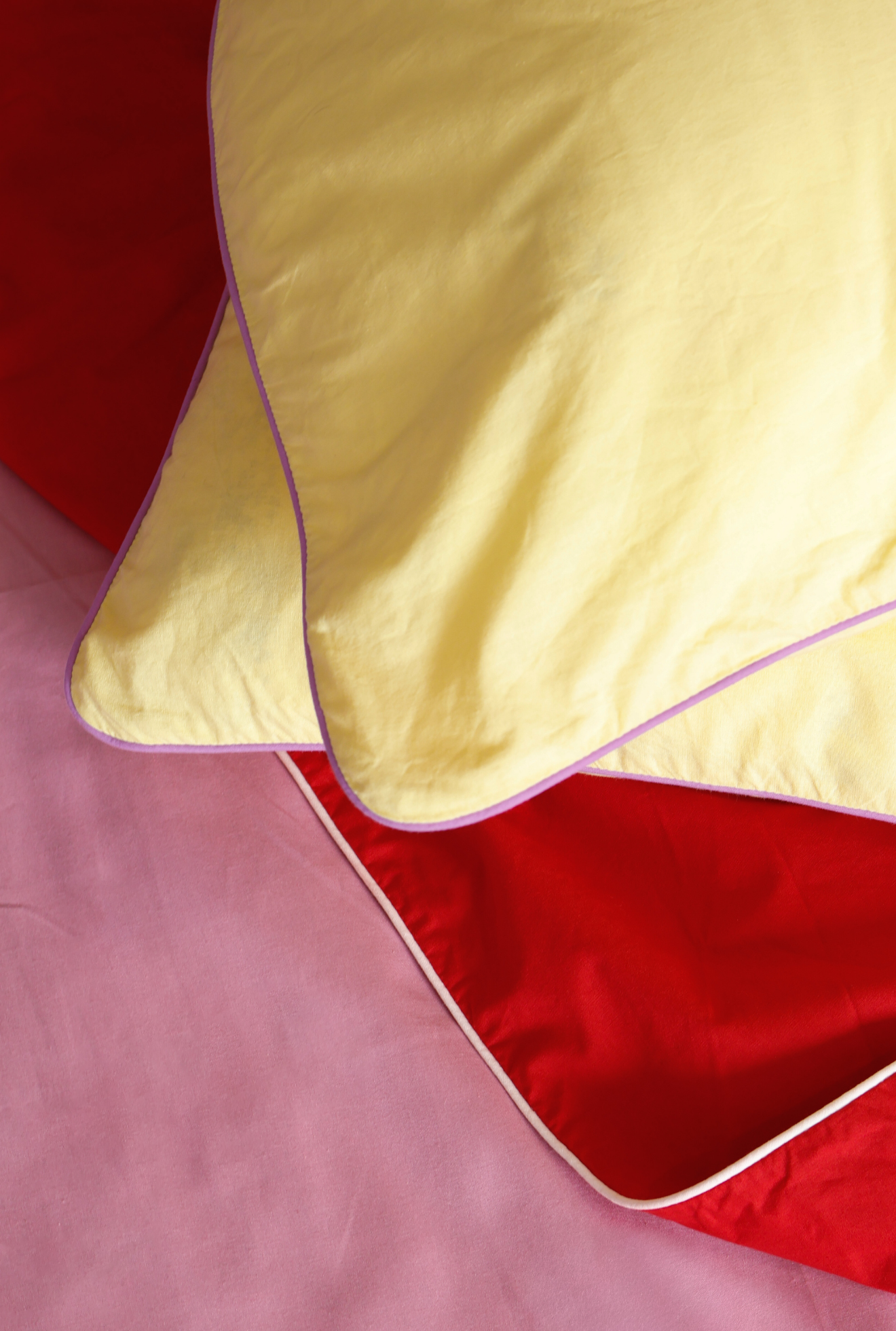 Yellow fabric on a red and pink background