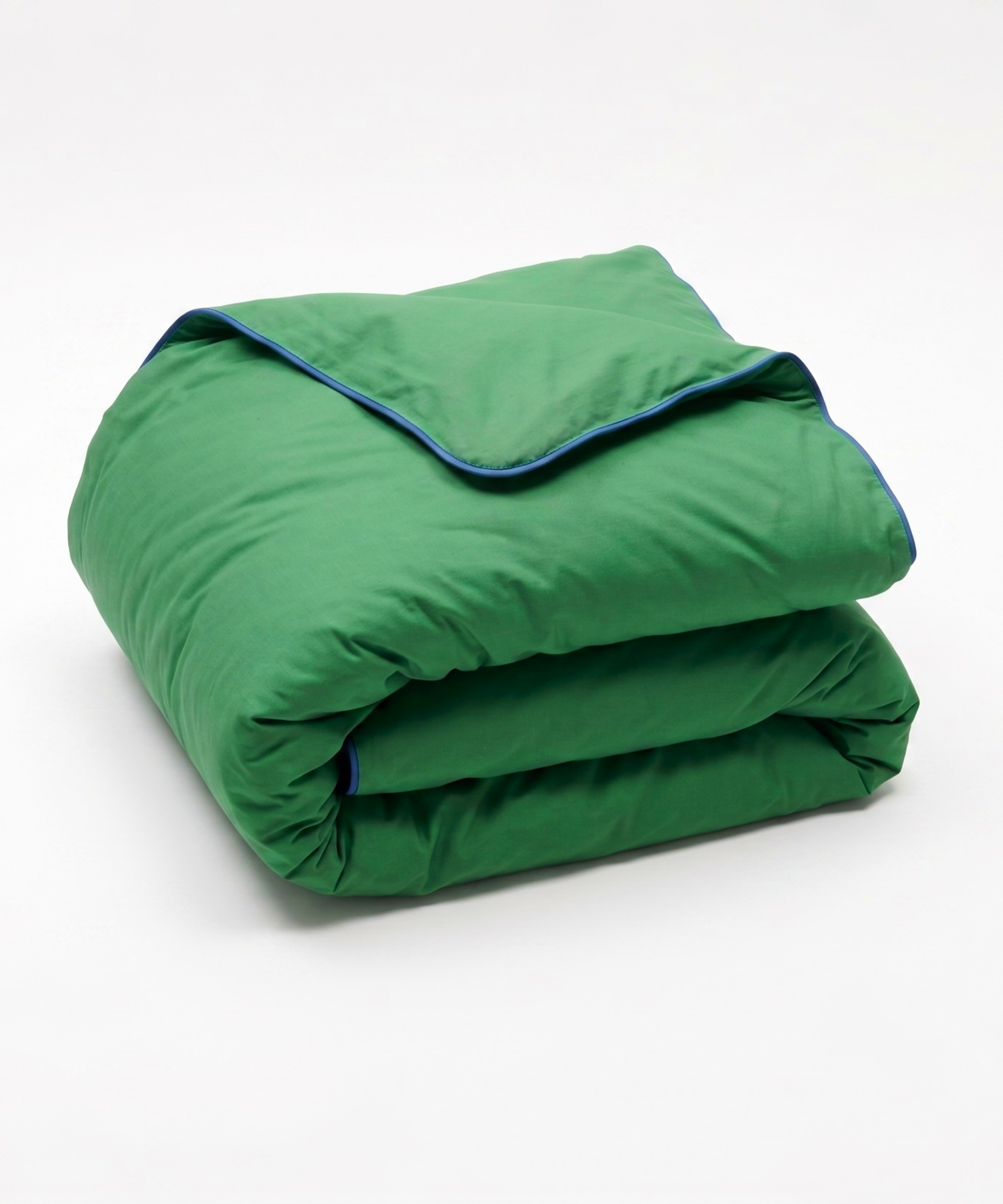 A folded green quilted comforter or duvet with a thin blue piping trim along the edge, shown on a clean white background.