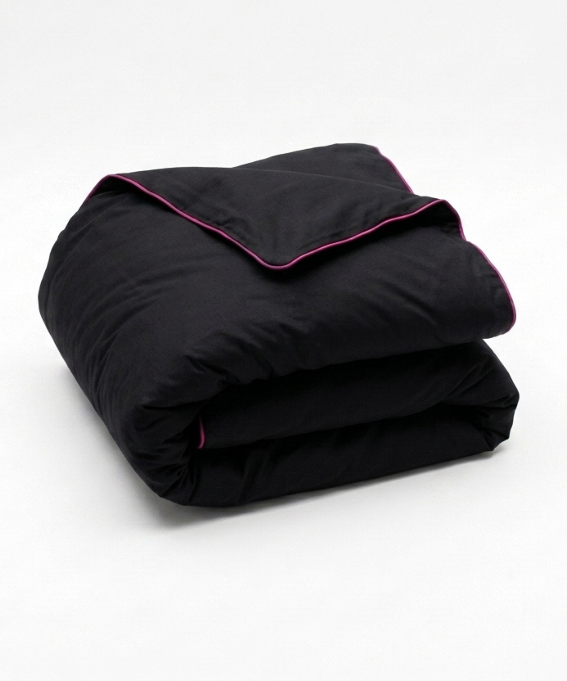 A folded black comforter or duvet with contrasting bright pink piping along the edges, shown on a clean white background.