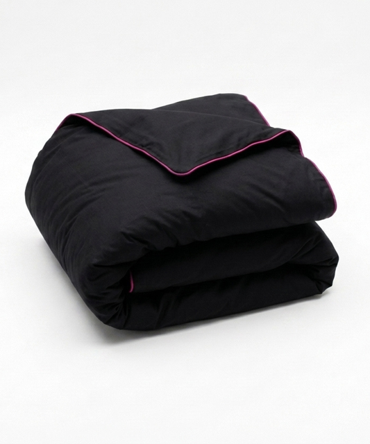 A folded black comforter or duvet with contrasting bright pink piping along the edges, shown on a clean white background.