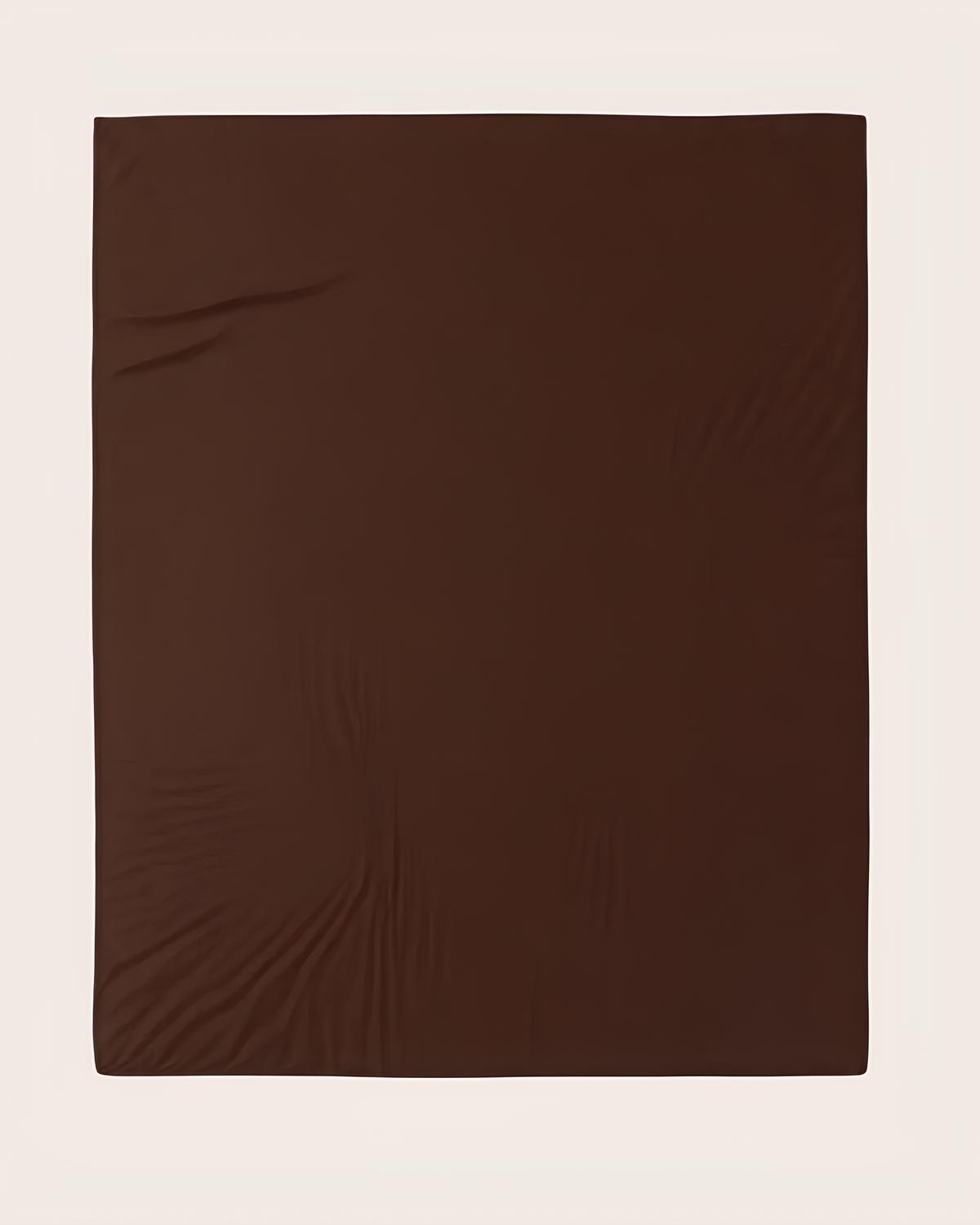 A dark brown fitted sheet laid flat against a light beige background.