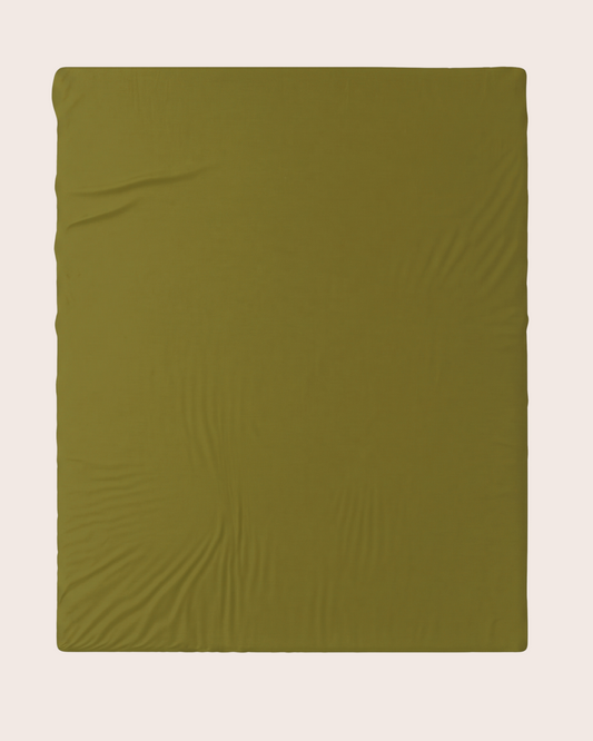 An olive green fitted sheet  laid flat against a light beige background.